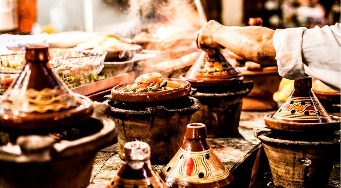 Traditional Moroccan tagine being opened at the table